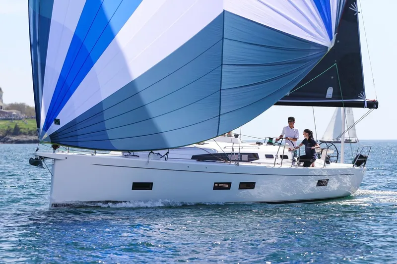 Slide: The Image of 2026 J Boats J/40 sailing on open water with vibrant blue sails. - 6
