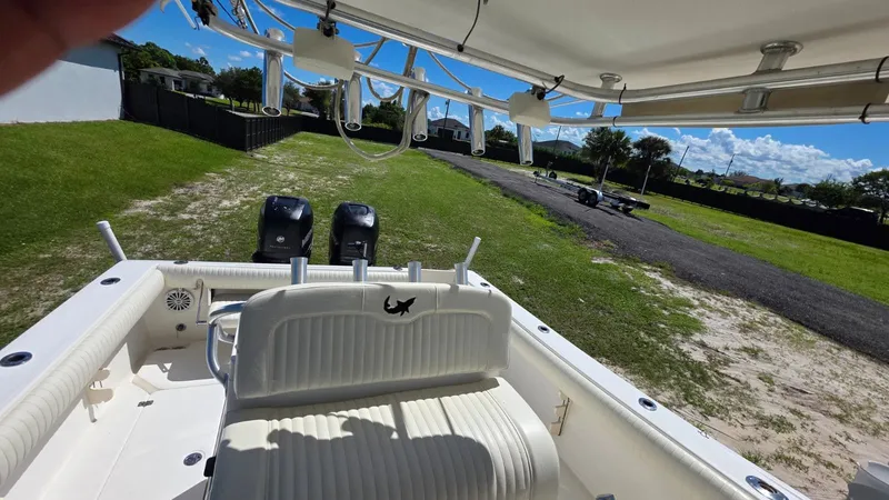 Slide: The Image of Mako 284 Center Console boat, 2020 model, parked on a grassy lawn. - 11