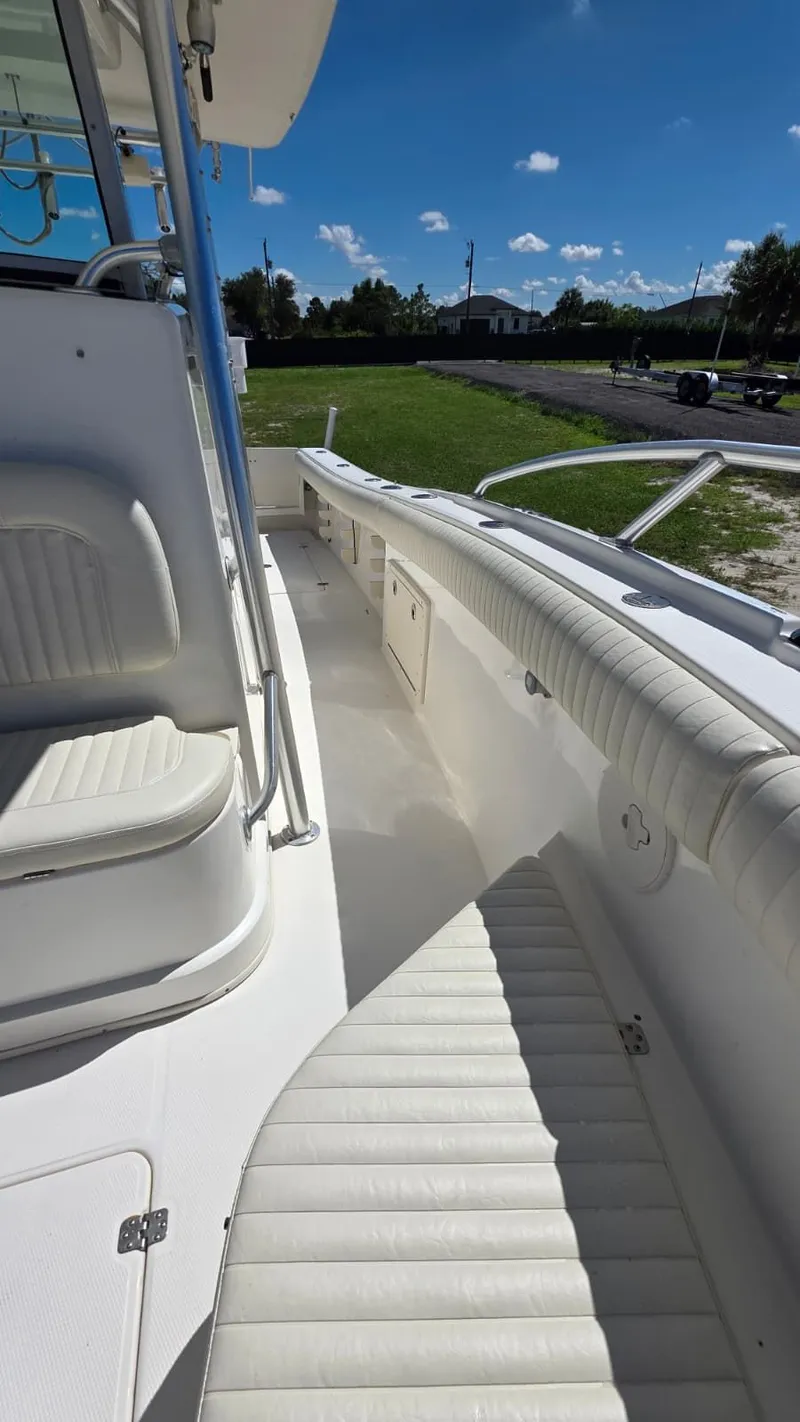 Slide: The Image of 2020 Mako 284 Center Console boat with white upholstery and blue sky. - 24