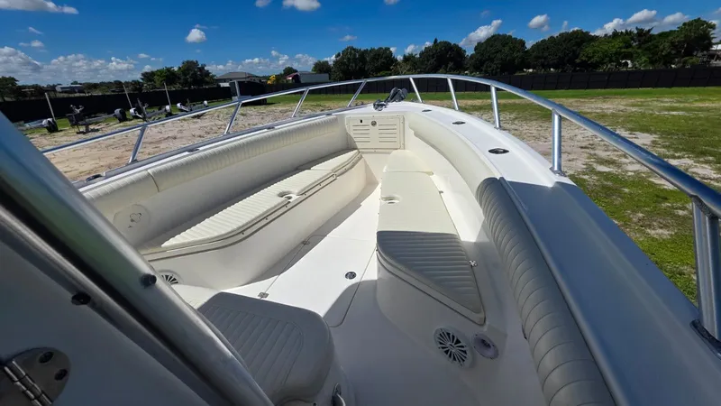 Slide: The Image of 2020 Mako 284 Center Console boat with spacious deck and seating area. - 26