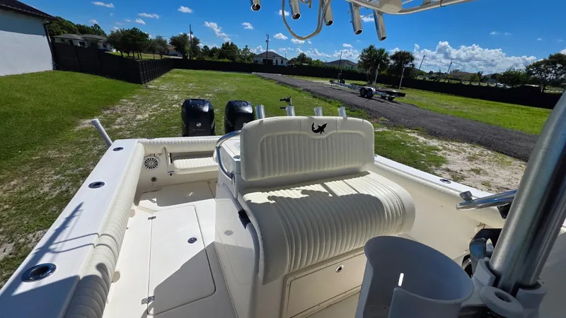 Slide: The Image of 2020 Mako 284 Center Console boat parked on grass. - 28