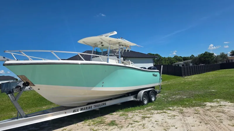 Slide: The Image of 2020 Mako 284 Center Console boat on trailer outdoors. - 6