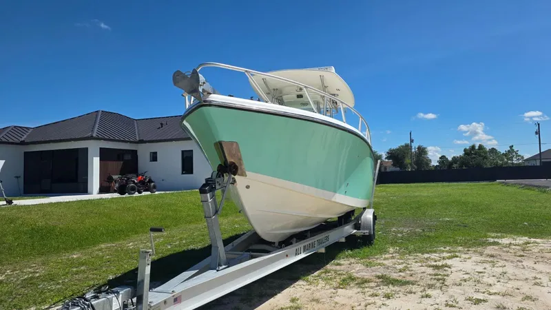 Slide: The Image of 2020 Mako 284 Center Console boat on trailer outdoors. - 7