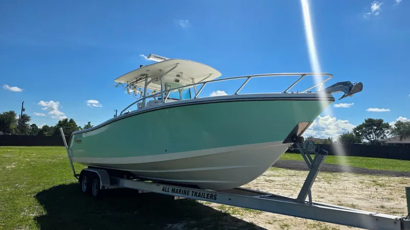 Slide: The Image of 2020 Mako 284 Center Console boat on trailer outdoors. - 8