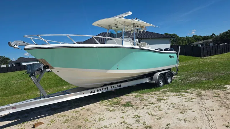 Slide: The Image of 2020 Mako 284 Center Console on trailer outdoors. - 9
