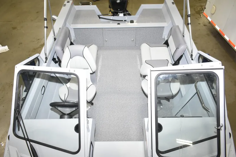 Slide: The Image of Interior of 2026 KingFisher 16 Falcon boat with steering wheel and seating. - 10