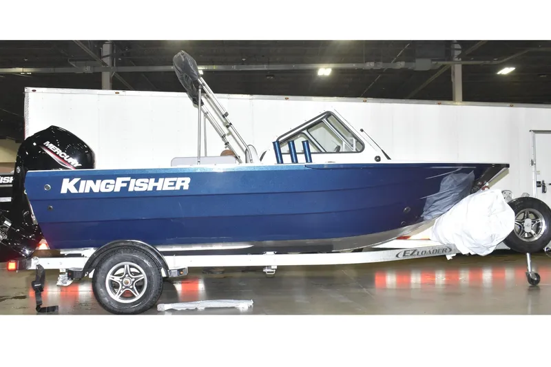 The Image of 2026 KingFisher 16 Falcon boat on trailer, blue exterior, indoor setting. - 0
