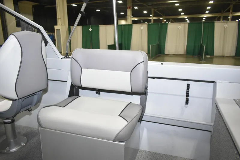 Slide: The Image of 2026 KingFisher 16 Falcon boat interior with storage compartment and seating. - 16