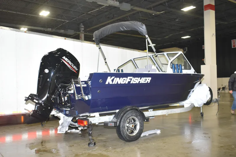Slide: The Image of 2026 KingFisher 16 Falcon boat on trailer in indoor showroom. - 2