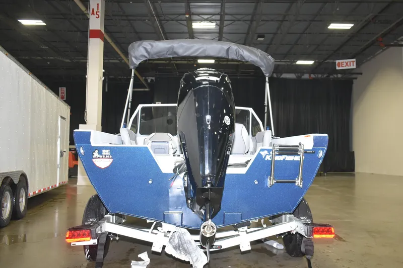 Slide: The Image of 2026 KingFisher 16 Falcon boat with Mercury outboard motor in a warehouse setting. - 5