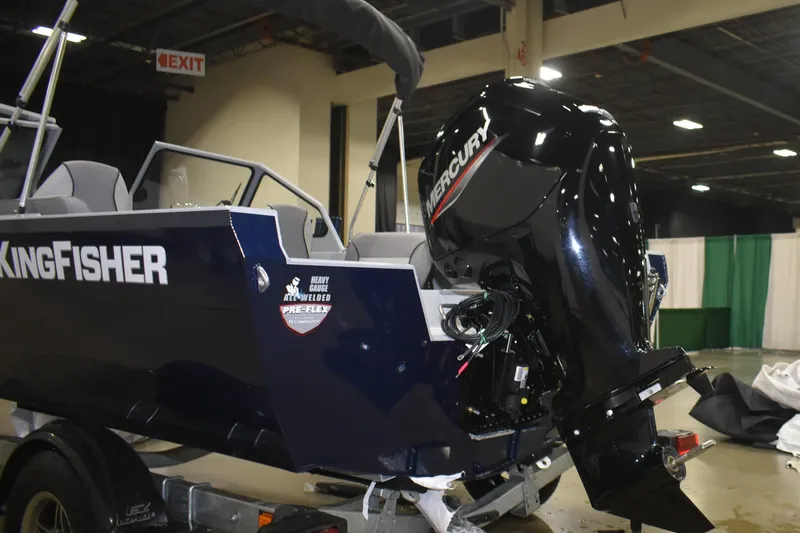 Slide: The Image of 2026 KingFisher 16 Falcon boat interior at an indoor exhibition, showcasing seating and windshield. - 7