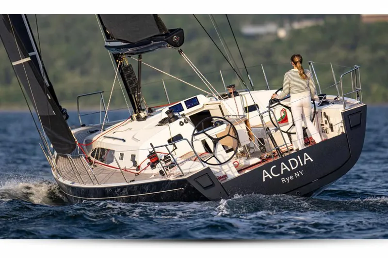 Slide: The Image of Manufacturer Provided Image: 2026 J Boats J/45 sailboat "Acadia" sailing with a person at the helm. - 0
