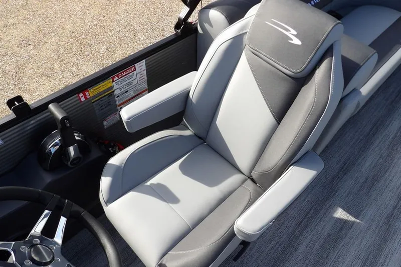 Slide: The Image of 2026 Bennington S 22 SSR boat interior with gray captain's chair and steering wheel. - 21