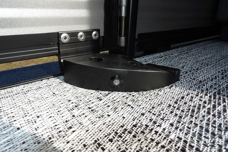 Slide: The Image of 2026 Bennington S 22 SSR boat detail, featuring a black hinge on textured flooring. - 32