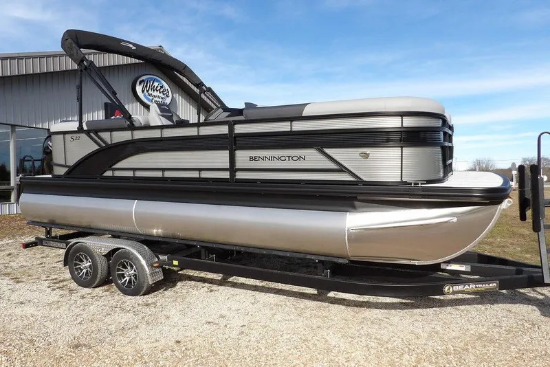 Slide: The Image of 2026 Bennington S 22 SSR pontoon boat on trailer, displayed outdoors. - 39