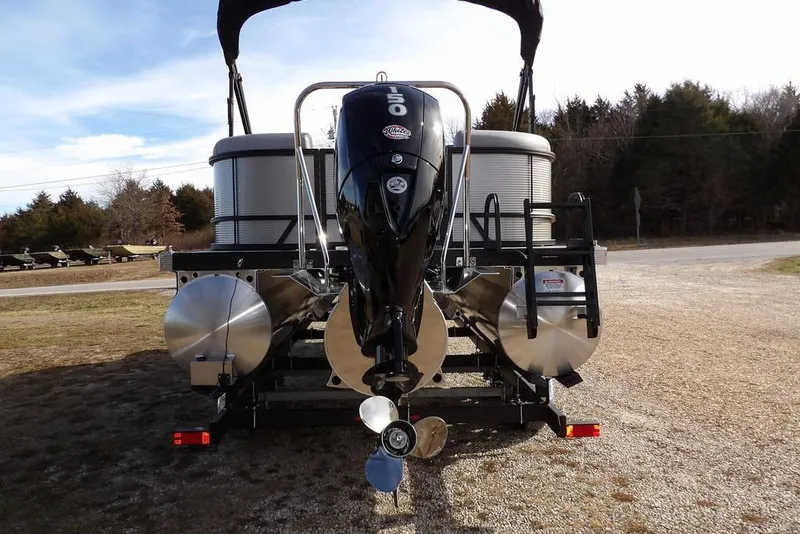 Slide: The Image of 2026 Bennington S 22 SSR pontoon boat with outboard motor, parked on gravel. - 7
