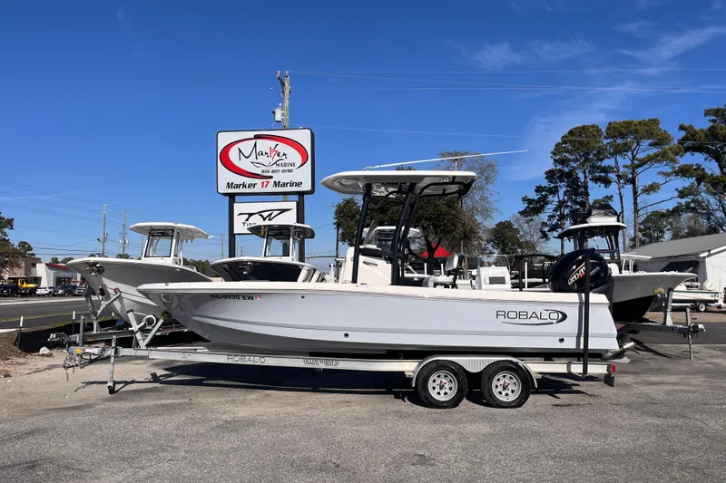 The Image of 2022 Robalo 226 Cayman boat on trailer at Marker 17 Marine dealership. - 0