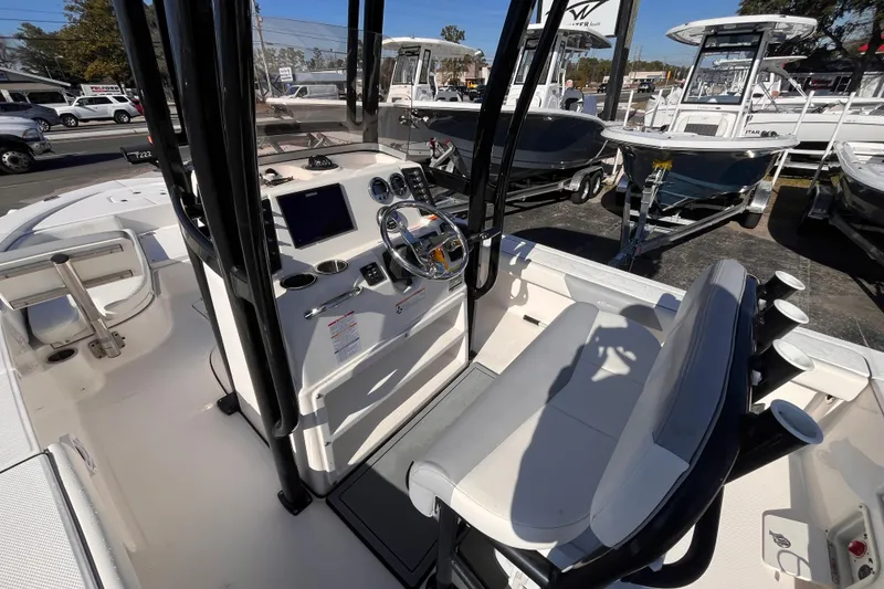 Slide: The Image of 2022 Robalo 226 Cayman boat interior with steering console and seating. - 15