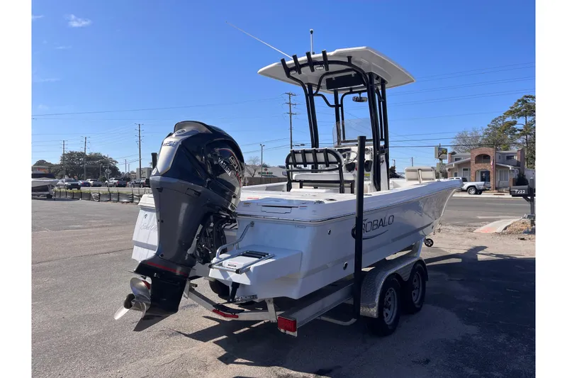 Slide: The Image of 2022 Robalo 226 Cayman boat on trailer with outboard motor in parking lot. - 4