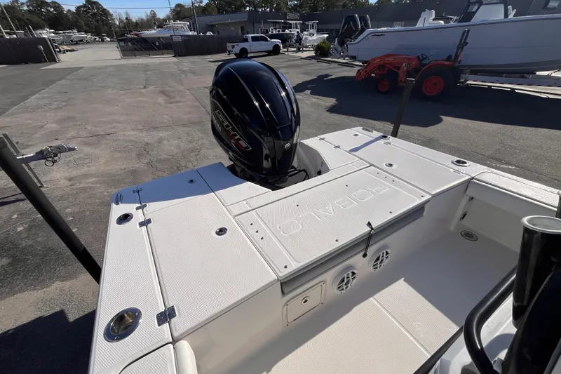 Slide: The Image of 2022 Robalo 226 Cayman boat with outboard motor, parked in a marina. - 5
