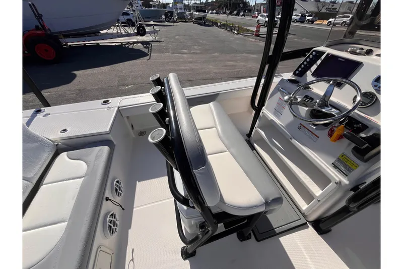 Slide: The Image of 2022 Robalo 226 Cayman boat interior with steering console and seating. - 7