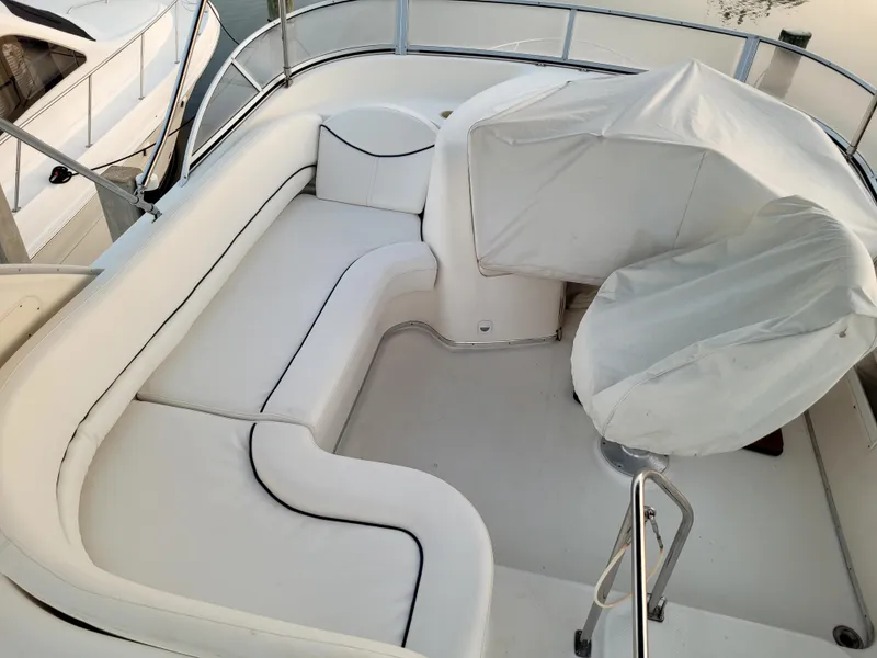 Slide: The Image of 2004 Meridian 341 Sedan boat interior with white seating and covered helm. - 11