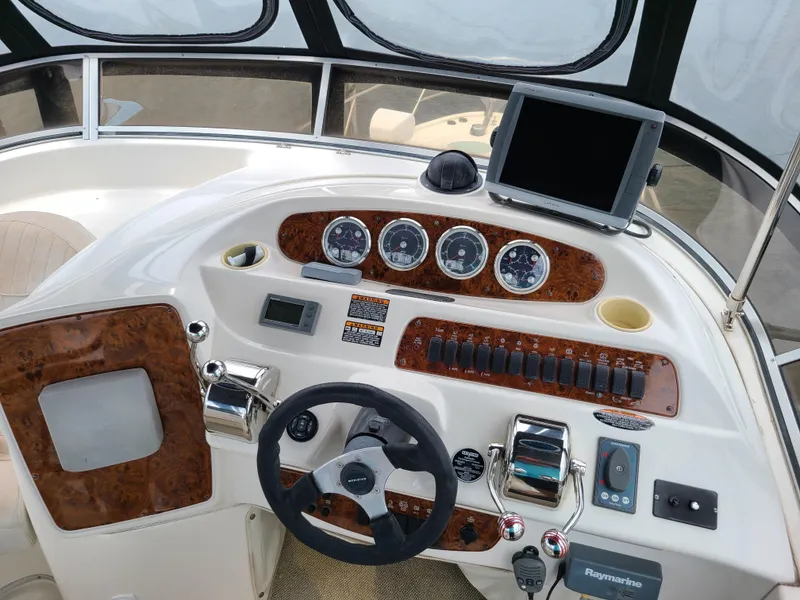 Slide: The Image of 2004 Meridian 341 Sedan helm with steering wheel, gauges, and navigation equipment. - 13