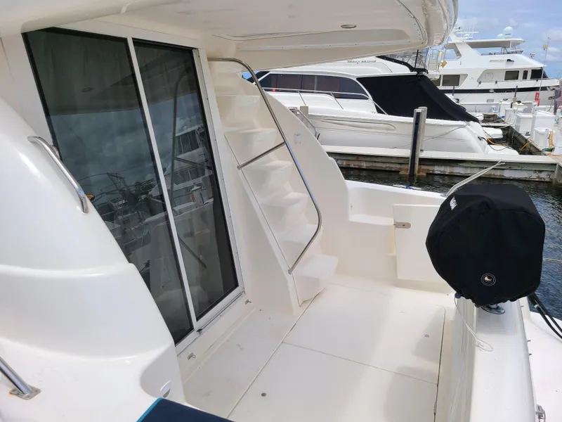Slide: The Image of 2004 Meridian 341 Sedan yacht deck with stairs and marina view. - 14