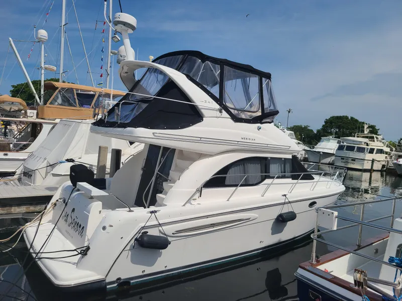 Slide: The Image of 2004 Meridian 341 Sedan yacht docked at marina under clear blue sky. - 4