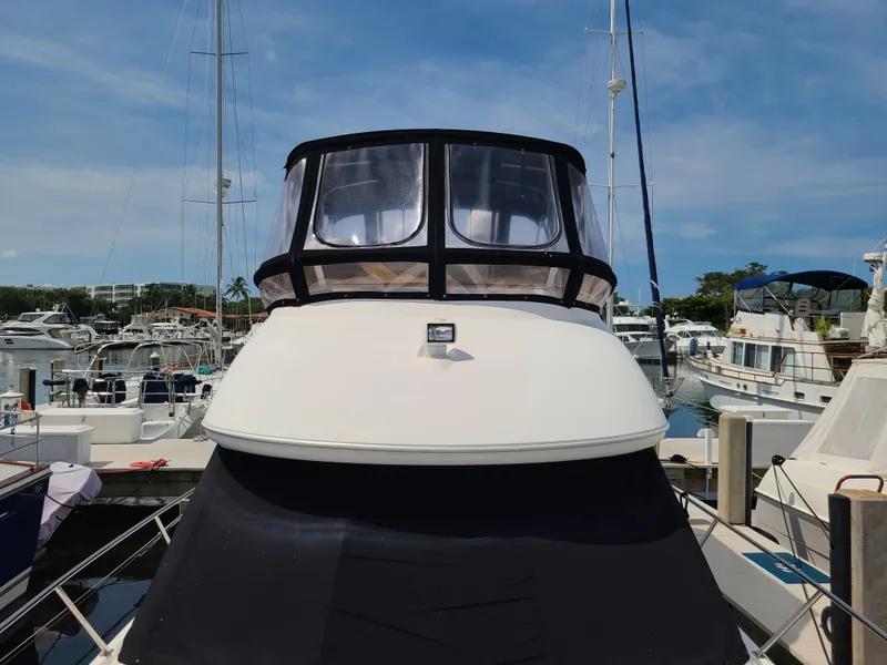 Slide: The Image of 2004 Meridian 341 Sedan yacht docked at a marina under a clear blue sky. - 6