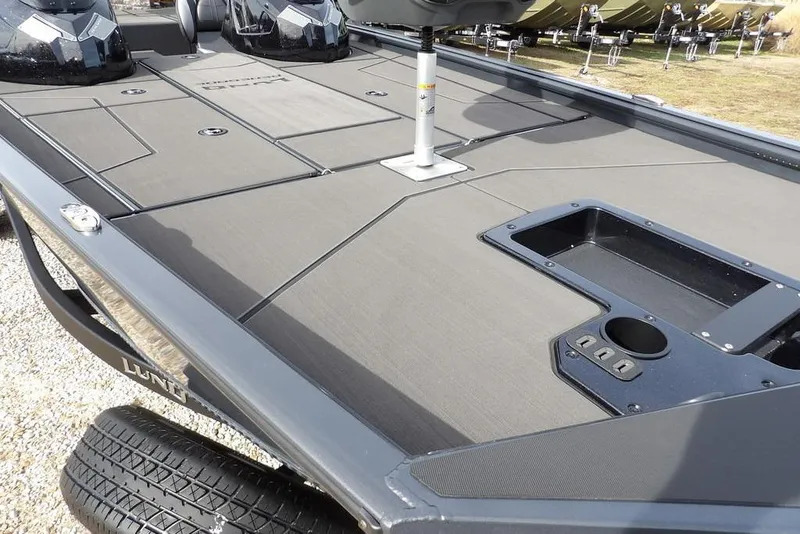 Slide: The Image of 2026 Lund 1975 Renegade boat deck with storage compartments and seating area. - 10