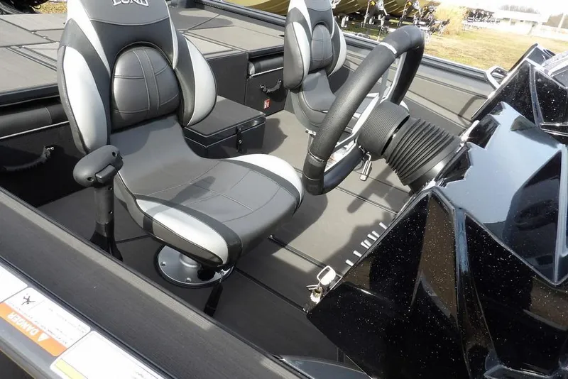 Slide: The Image of Interior of 2026 Lund 1975 Renegade boat with modern seating and steering wheel. - 11