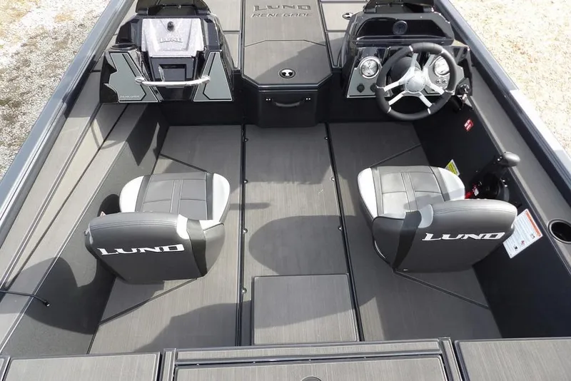 Slide: The Image of 2026 Lund 1975 Renegade boat interior with dual seats and steering console. - 17