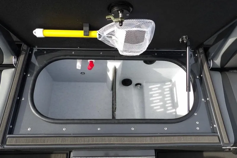 Slide: The Image of Livewell compartment in 2026 Lund 1975 Renegade boat with net and yellow handle. - 19