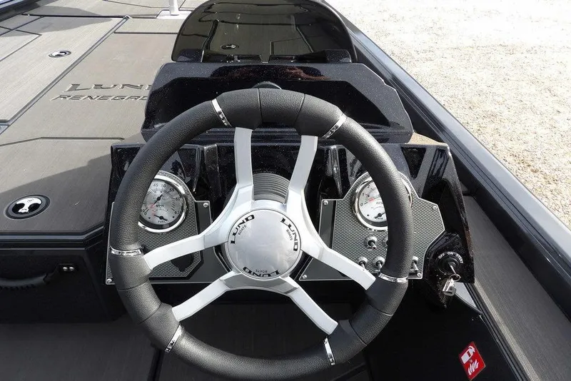 Slide: The Image of Steering wheel of 2026 Lund 1975 Renegade boat with dashboard gauges. - 23