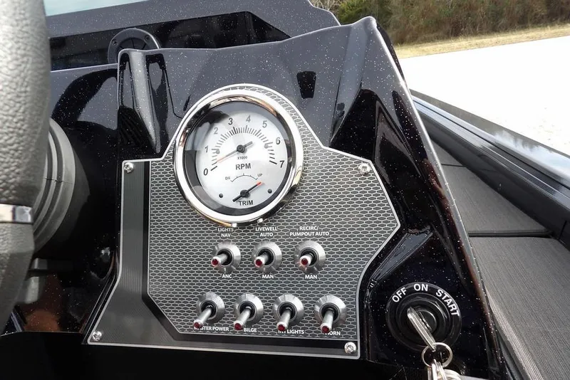 Slide: The Image of Dashboard of 2026 Lund 1975 Renegade boat with RPM gauge and control switches. - 25