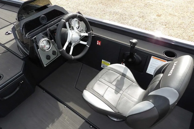 Slide: The Image of Interior of 2026 Lund 1975 Renegade boat with steering wheel and seat. - 26