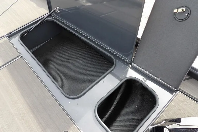 Slide: The Image of Open storage compartments on a 2026 Lund 1975 Renegade boat deck. - 30