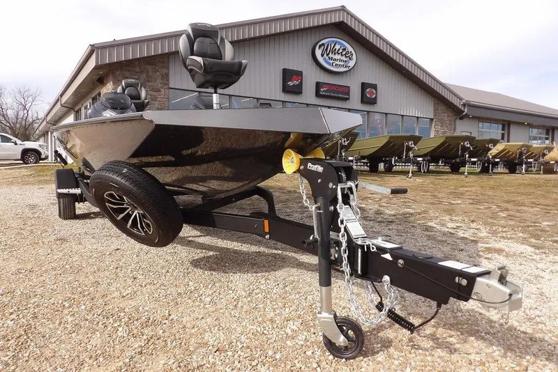 Slide: The Image of 2026 Lund 1975 Renegade boat on trailer outside marine center. - 36