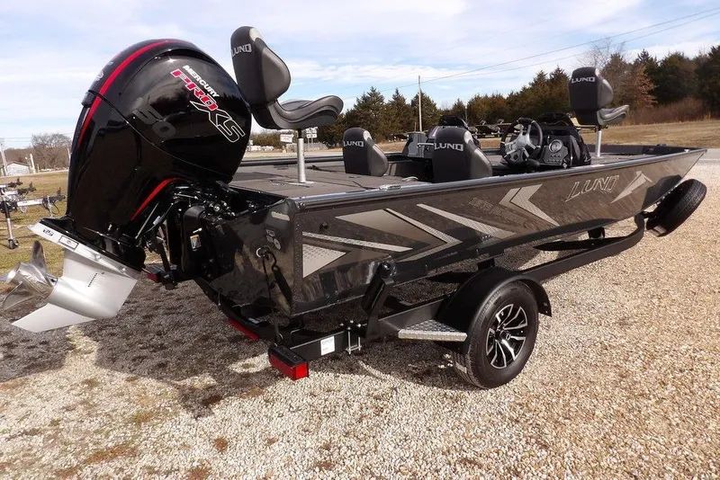 Slide: The Image of 2026 Lund 1975 Renegade boat with powerful outboard motor on a trailer. - 7