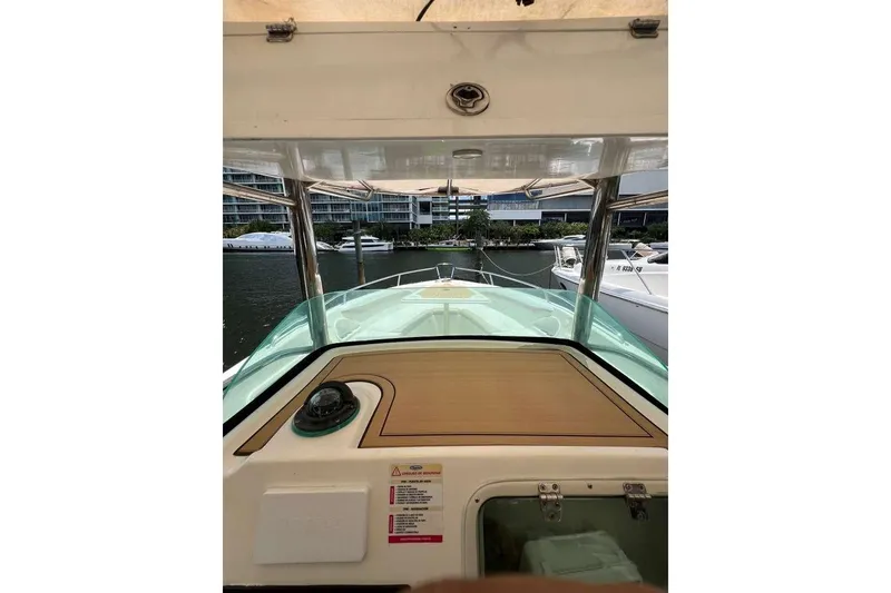 Slide: The Image of 2002 Promarine 33 SFs boat interior view with modern dashboard and waterfront backdrop. - 3