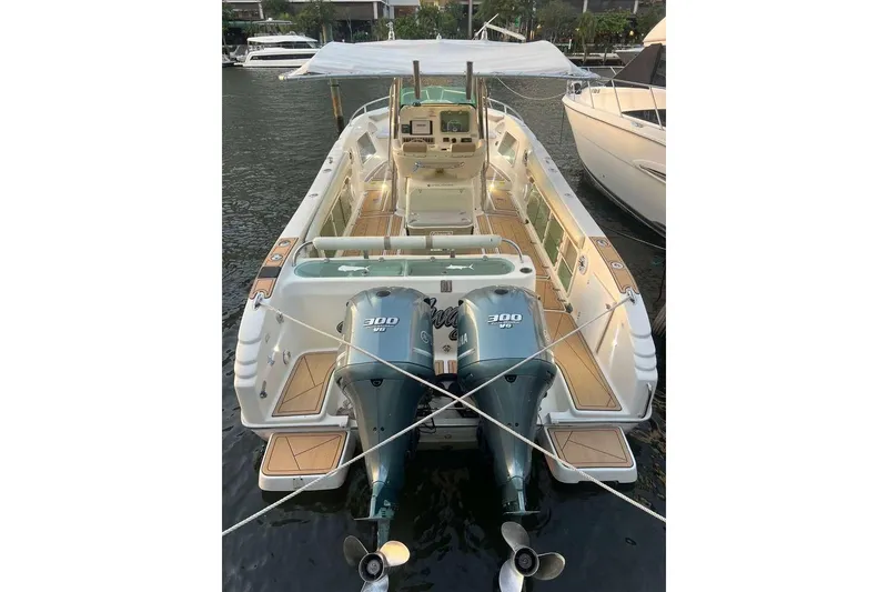 Slide: The Image of 2002 Promarine 33 SFs boat with twin 300 HP engines docked at marina. - 4