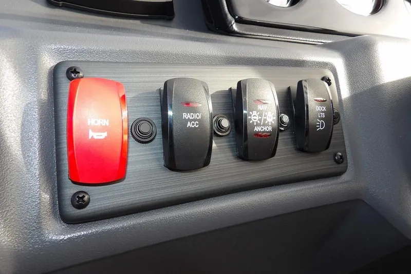 Slide: The Image of Control panel of 2026 Bennington S 22 SSR with horn, radio, navigation, and dock light switches. - 20