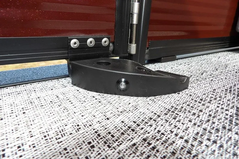 Slide: The Image of Close-up of a 2026 Bennington S 22 SSR boat hinge and latch on textured flooring. - 35