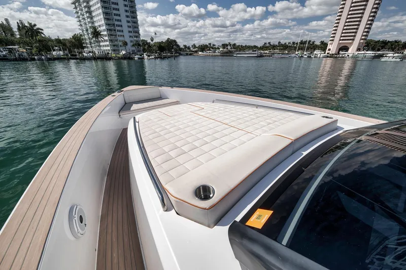 Slide: The Image of 2023 Pardo Yachts P43 luxury yacht with sunbathing deck, docked in a scenic marina. - 11