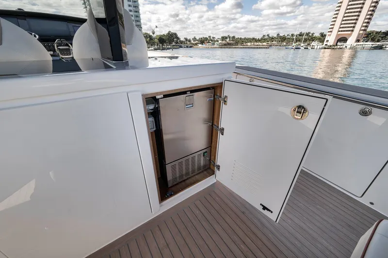 Slide: The Image of 2023 Pardo Yachts P43 interior with open storage compartment, dockside view. - 14