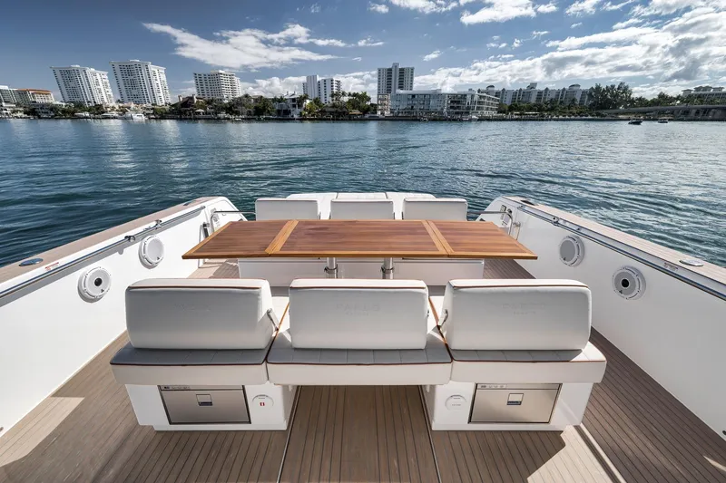 Slide: The Image of Luxury 2023 Pardo Yachts P43 deck with seating and table, overlooking waterfront skyline. - 18