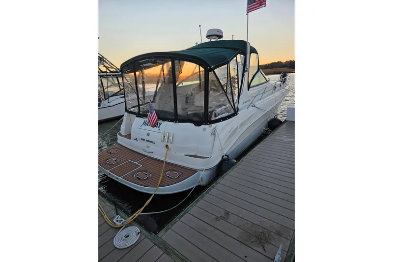 The Image of 2000 Sea Ray 340 Sundancer docked at sunset with American flag. - 0