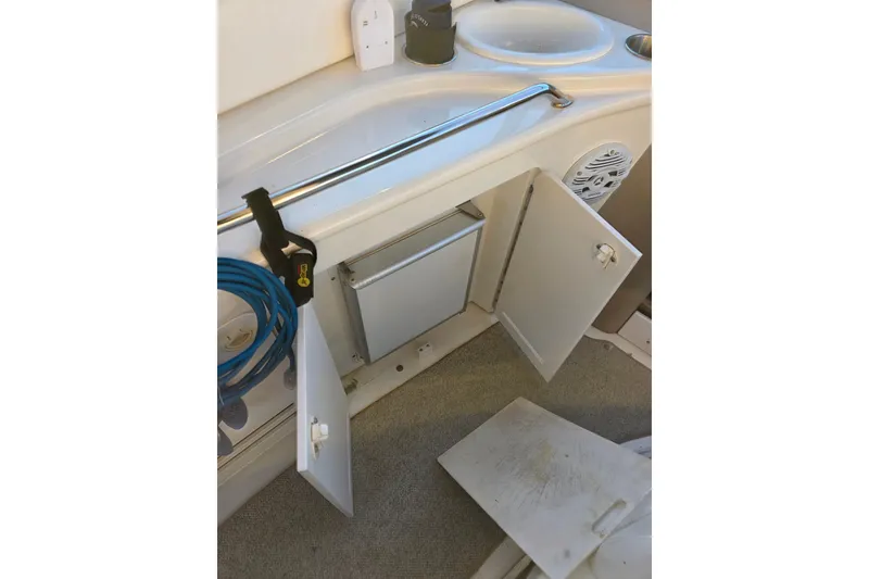 Slide: The Image of 2000 Sea Ray 340 Sundancer interior with open cabinet and sink area. - 45