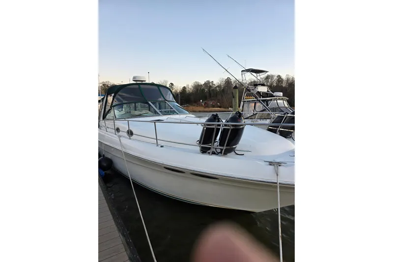 Slide: The Image of 2000 Sea Ray 340 Sundancer docked at marina, side view with clear sky. - 60